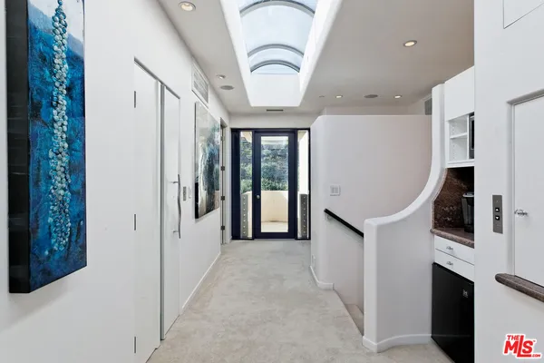a bathroom with a granite countertop sink a mirror and a toilet