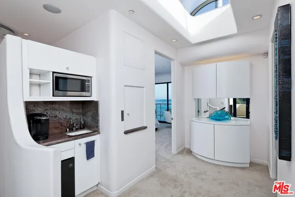 a living room with furniture and a painting on the wall