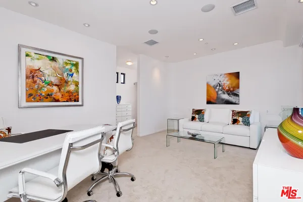 a bedroom with a bed and a wall painting