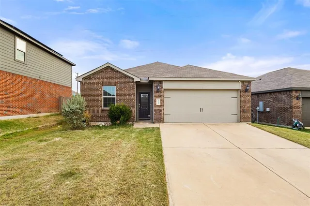 a view of garage yard and front view of a house