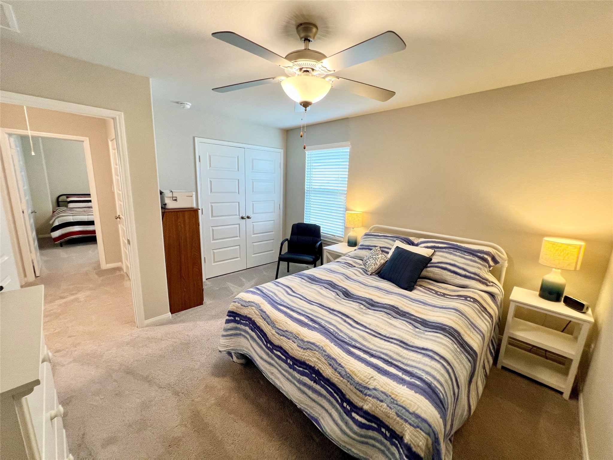 10013 Hermann Trace Texas City, TX 77591 - Photo 16 of 22 a bedroom with a bed and a chandelier