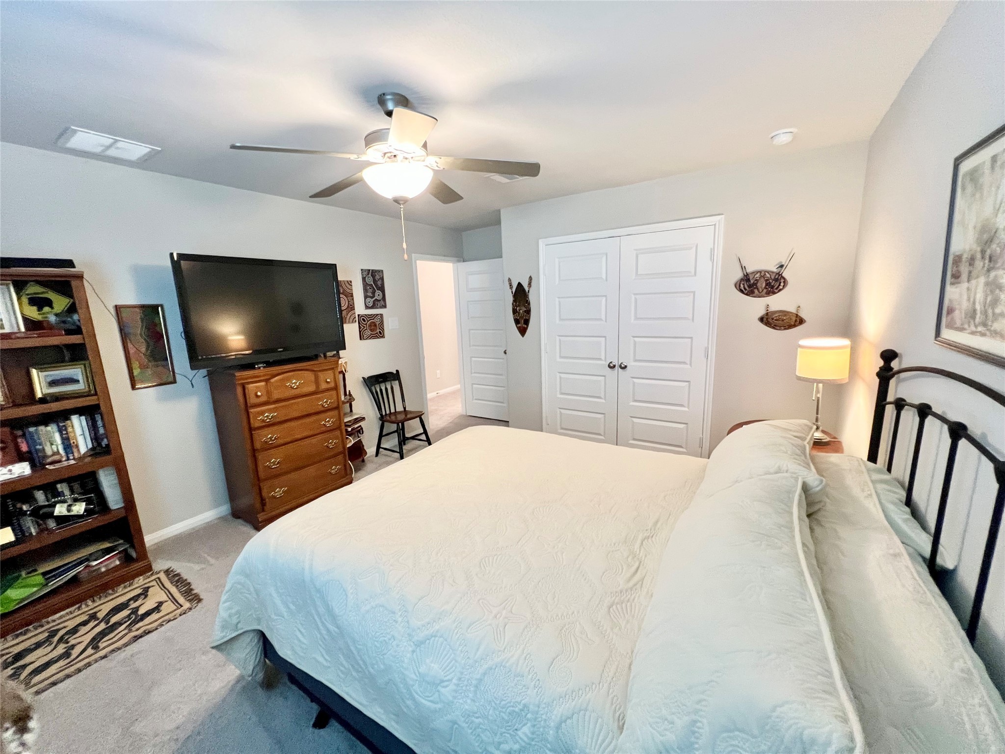 10013 Hermann Trace Texas City, TX 77591 - Photo 20 of 22 a bedroom with a bed and a flat screen tv