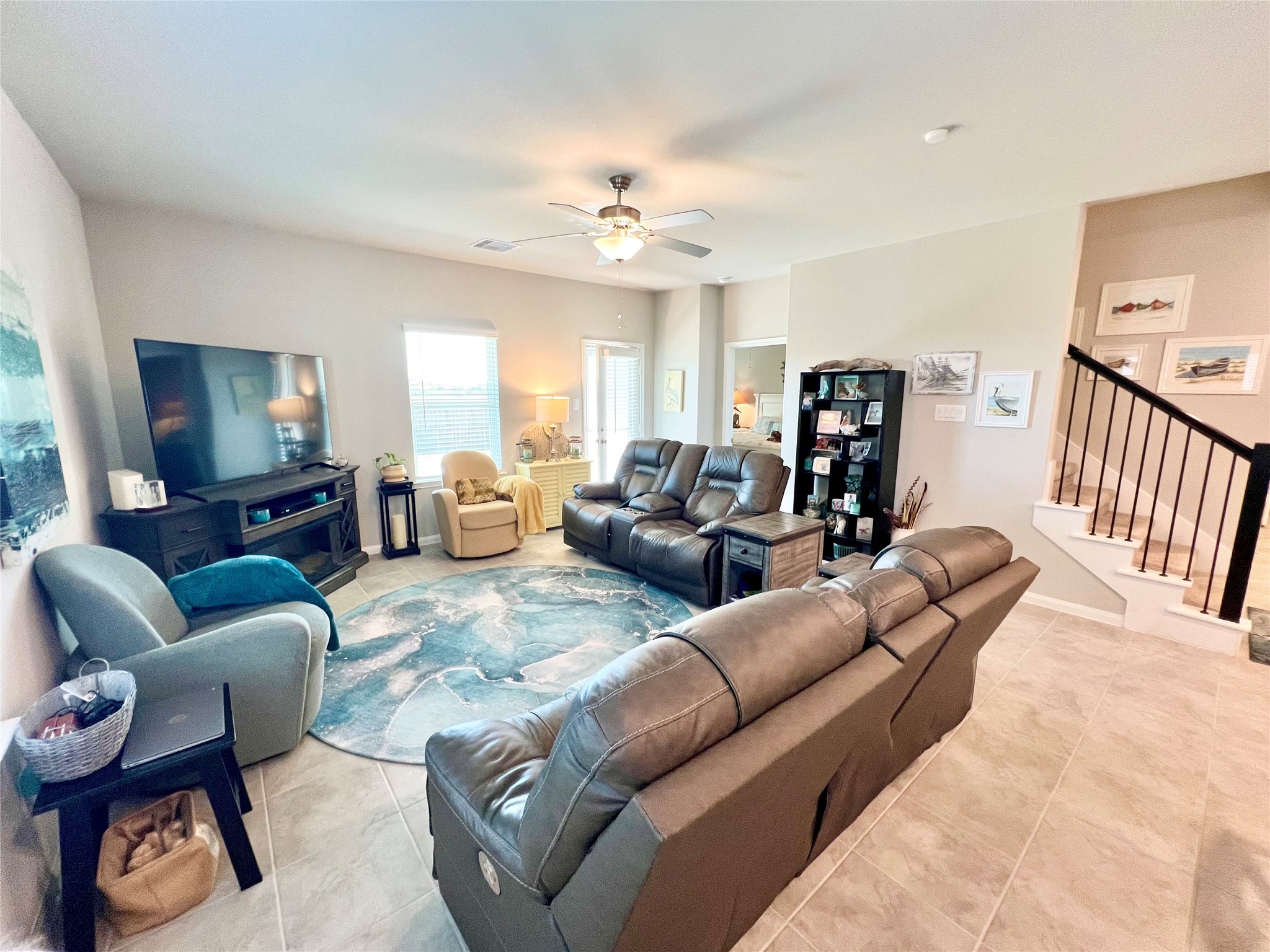 10013 Hermann Trace Texas City, TX 77591 - Photo 8 of 22 a living room with furniture a flat screen tv and a chandelier