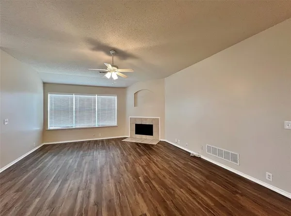 a view of a room with wooden floor and fireplace
