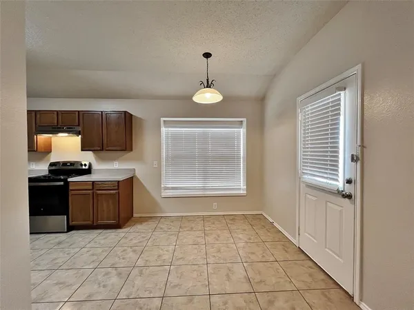 a kitchen with a stove a sink and a refrigerator