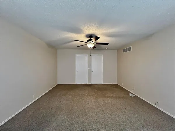 a view of a room with a ceiling fan