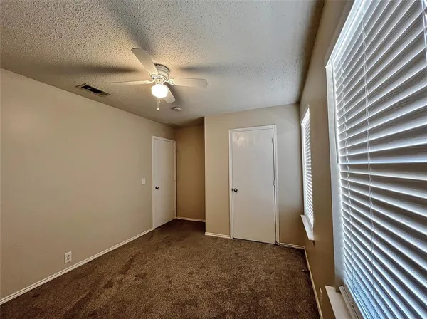 a view of empty room with ceiling fan