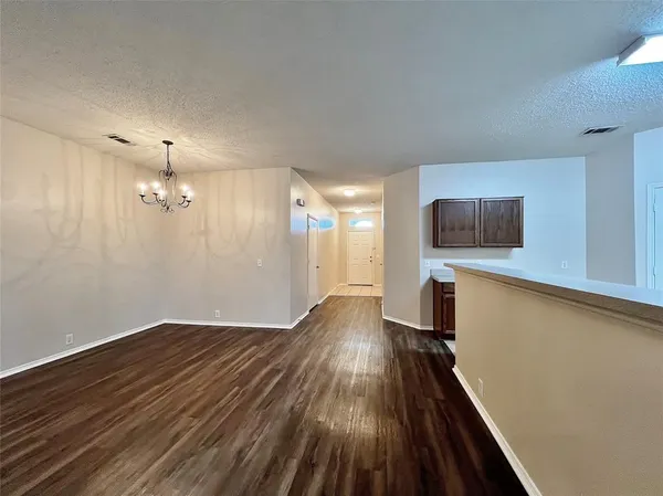 a view of a room with wooden floor and a window