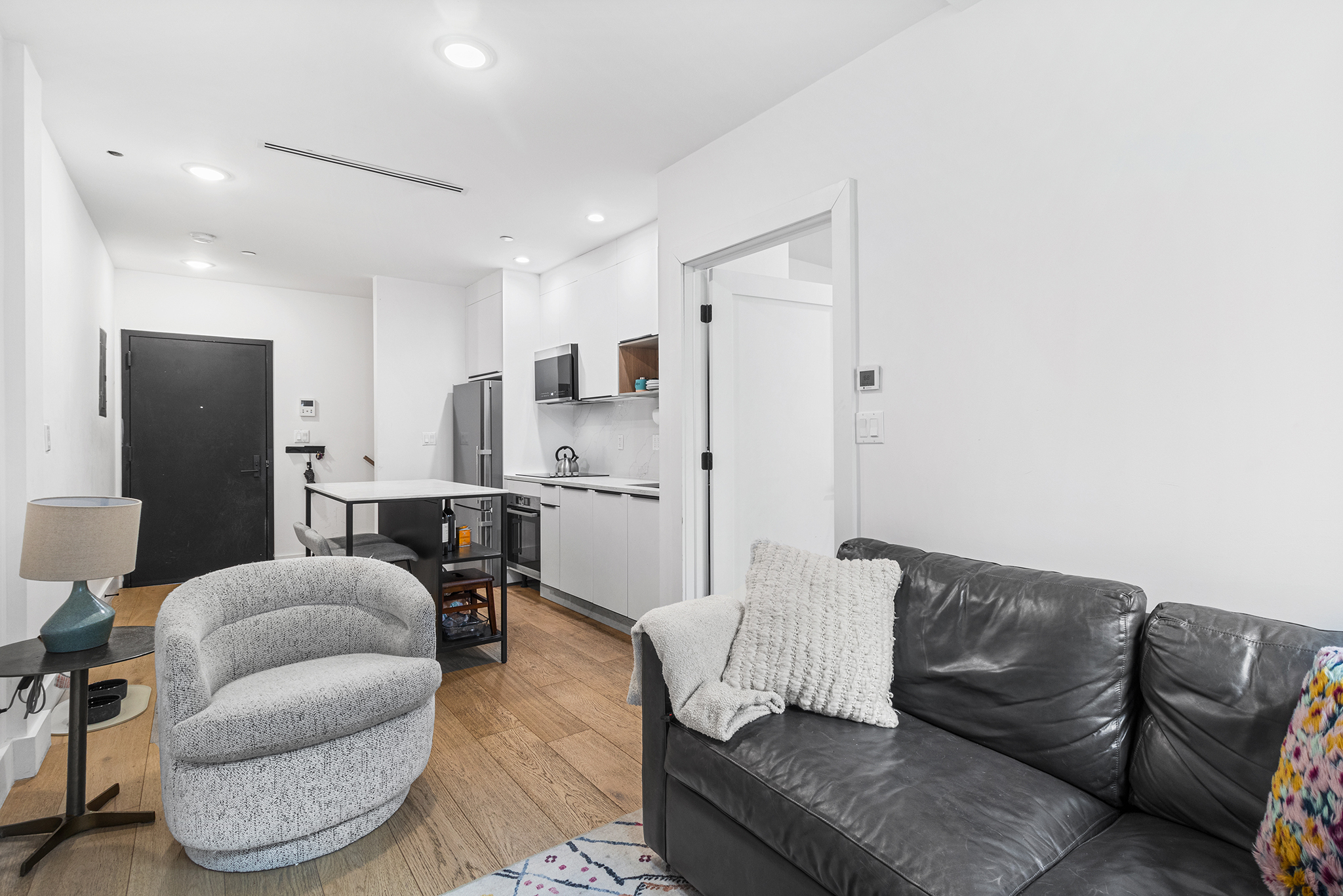31 Bleecker Street, Unit 1R Brooklyn, NY 11221 - Photo 10 of 19 a living room with furniture and kitchen view
