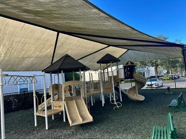 a view of a patio with table and chairs under an umbrella
