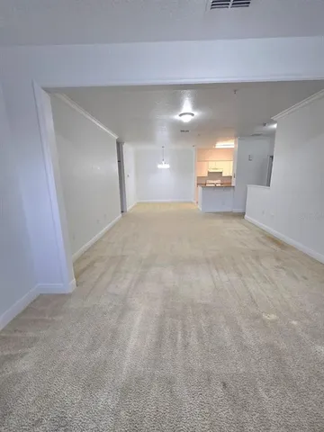 a view of a hallway to room with window and stairs