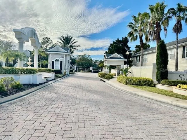 a front view of a house with a yard and potted plants