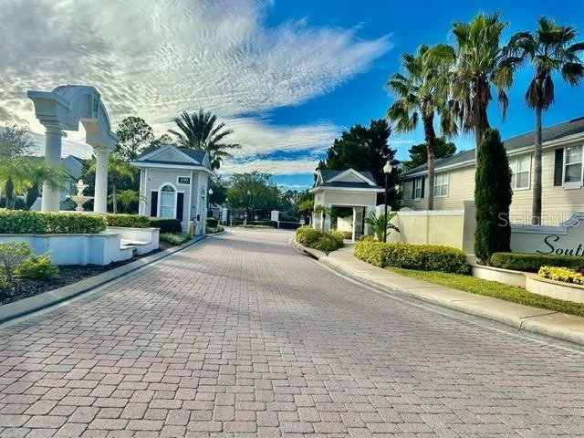 a front view of a house with a yard and potted plants