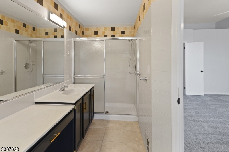 93 Birchwood Road Bedminster, NJ 07921 - Photo 13 of 18 a bathroom with a sink mirror and shower