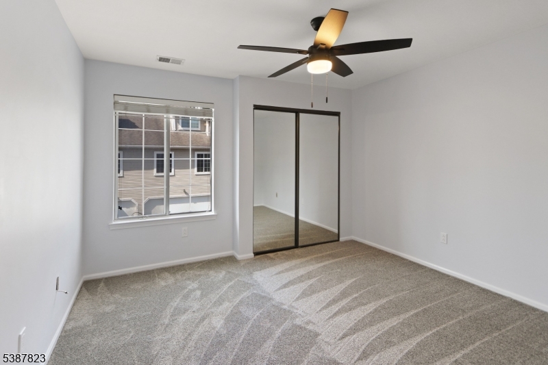 93 Birchwood Road Bedminster, NJ 07921 - Photo 15 of 18 an empty room with windows and fan