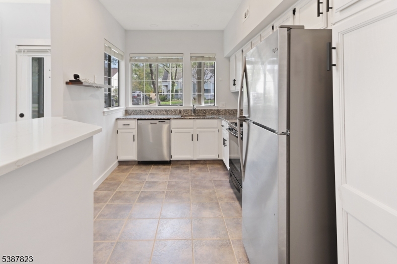 93 Birchwood Road Bedminster, NJ 07921 - Photo 5 of 18 a kitchen with a refrigerator and a sink