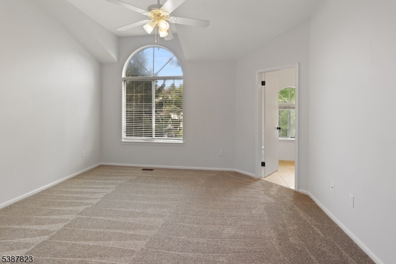 93 Birchwood Road Bedminster, NJ 07921 - Photo 10 of 18 an empty room with chandelier fan and windows