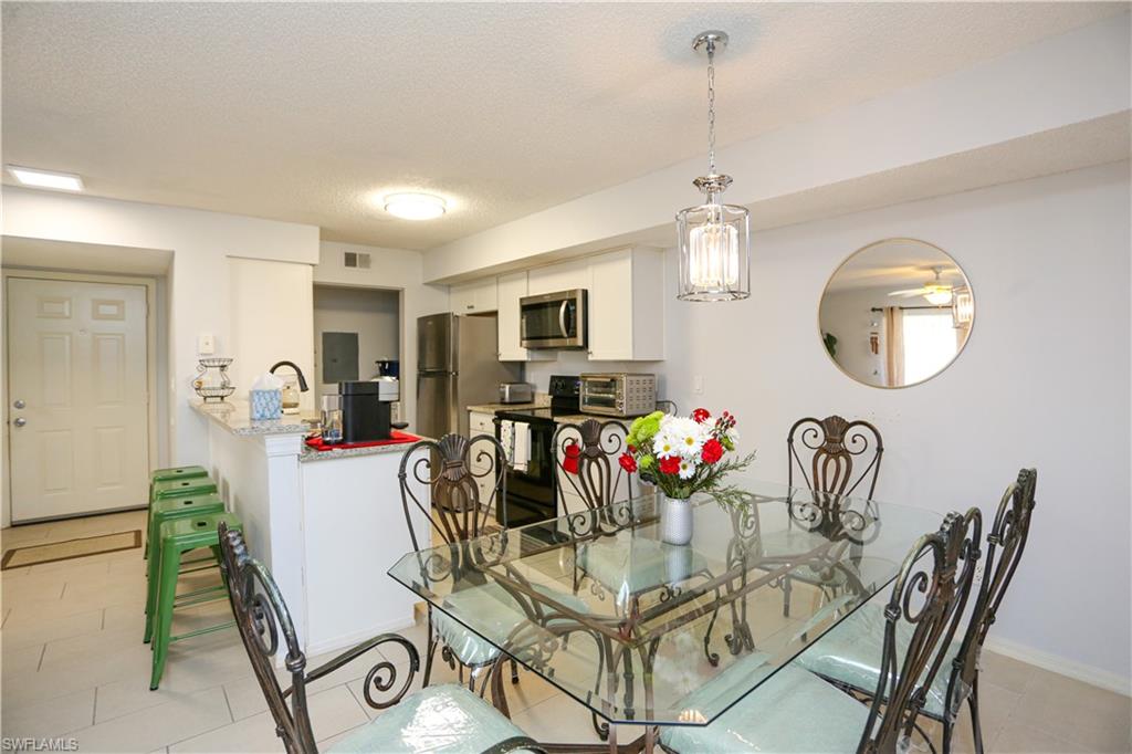 2214 Arbour Walk Circle, Unit 2012 Naples, FL 34109 - Photo 11 of 29 a view of a dining room and a livingroom