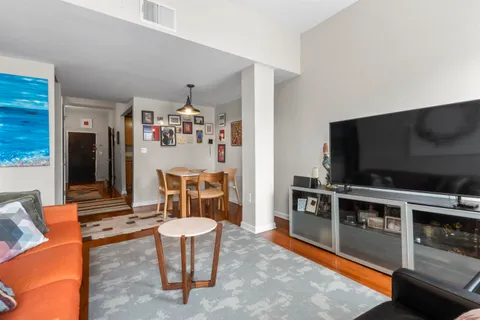 a living room with furniture and a baby crib