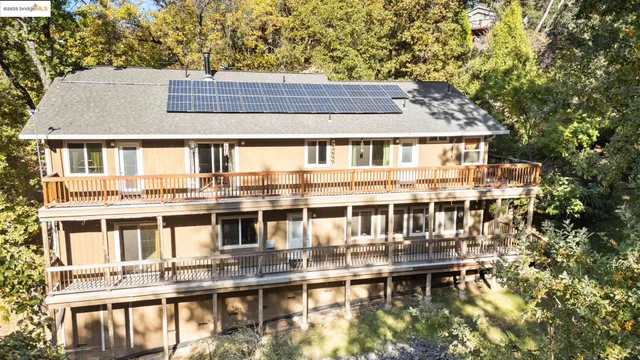 a living room with furniture a fireplace and a chandelier