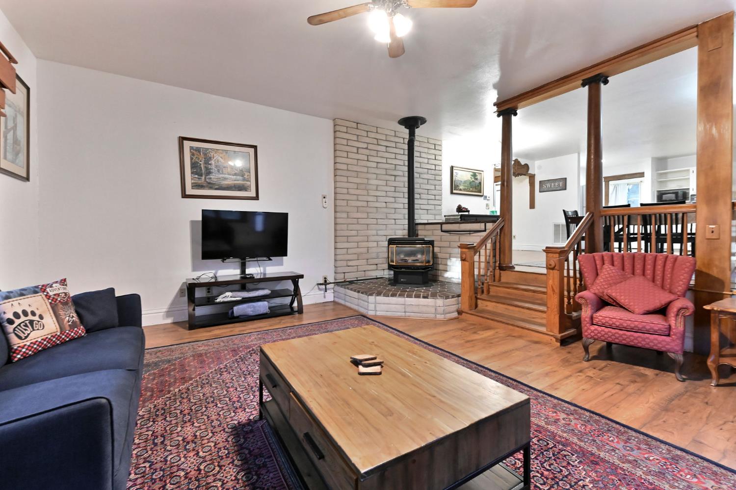 5276 Highway 4 Murphys, CA 95247 - Photo 17 of 69 a living room with furniture a flat screen tv and a floor to ceiling window