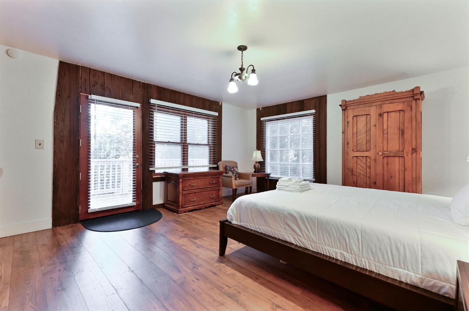 5276 Highway 4 Murphys, CA 95247 - Photo 20 of 69 a bedroom with a large bed and a large window