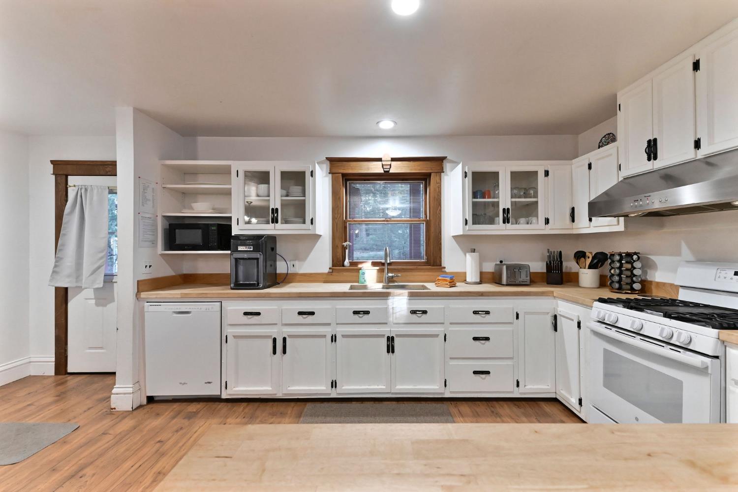 5276 Highway 4 Murphys, CA 95247 - Photo 2 of 69 a kitchen with granite countertop a stove and white cabinets