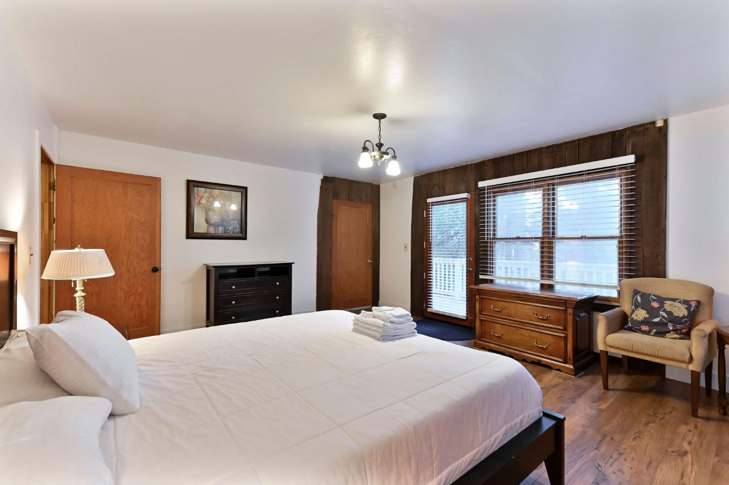 5276 Highway 4 Murphys, CA 95247 - Photo 23 of 69 a bedroom with a large bed and a chandelier