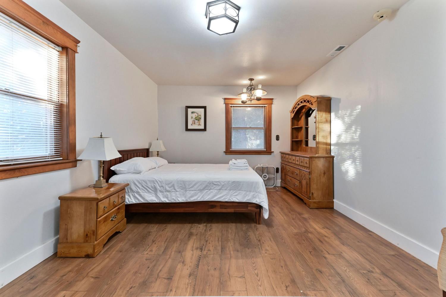 5276 Highway 4 Murphys, CA 95247 - Photo 35 of 69 a bedroom with a bed lamps cabinets and window