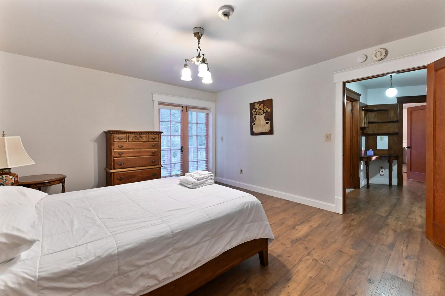 5276 Highway 4 Murphys, CA 95247 - Photo 49 of 69 a bedroom with a large bed and a chandelier