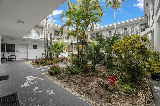 a view of a house with a flower garden