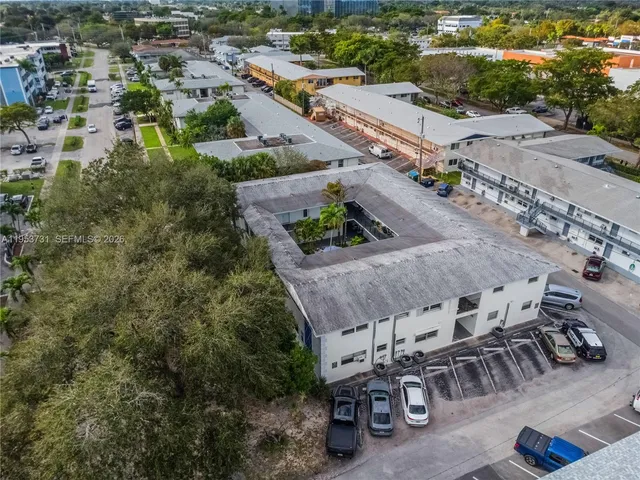 an aerial view of a swimming pool with outdoor seating