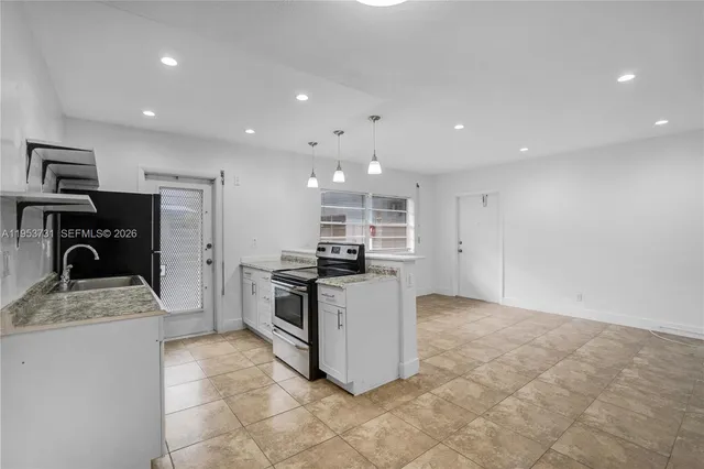 a kitchen with refrigerator and microwave