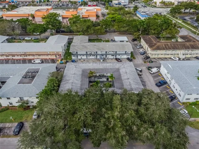 an aerial view of a house with a yard and lake view