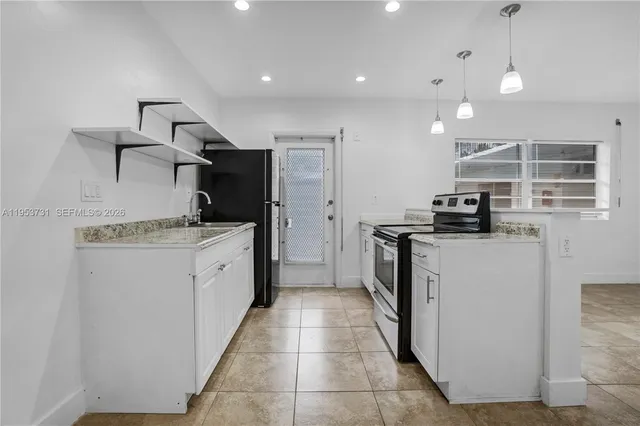 a kitchen with a sink and stainless steel appliances