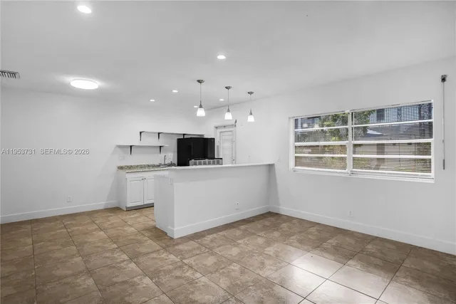 a view of kitchen with microwave and cabinets