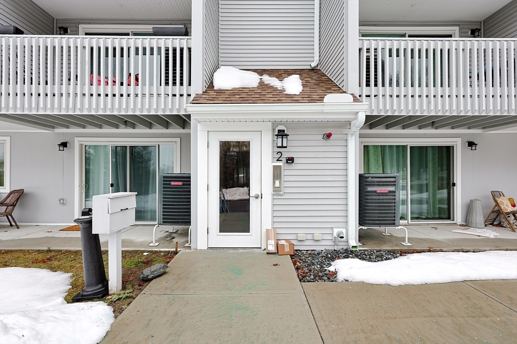 212 Franklin Crossing Road, Unit 12 Franklin, MA 02038 - Photo 1 of 11 a front view of a house with a yard