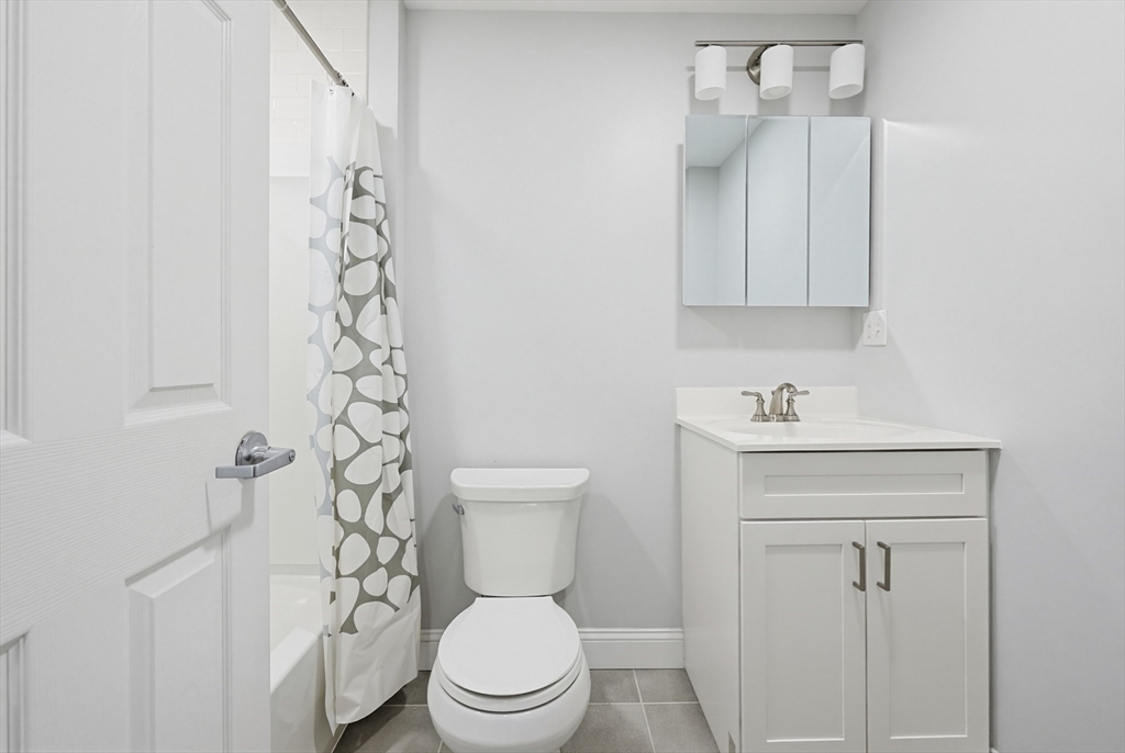 212 Franklin Crossing Road, Unit 12 Franklin, MA 02038 - Photo 2 of 11 a bathroom with a toilet a sink and a shower