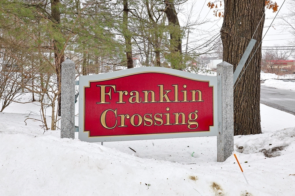 212 Franklin Crossing Road, Unit 12 Franklin, MA 02038 - Photo 10 of 11 a sign broad on the side of the road