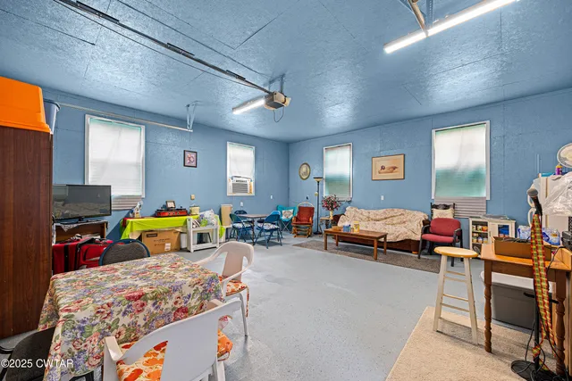 a bedroom with furniture and a flat screen tv
