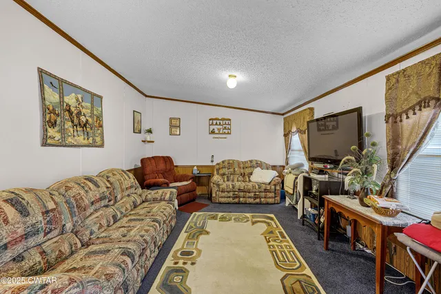 a bedroom with furniture and a flat screen tv