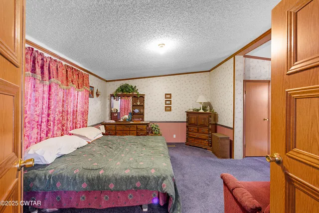 a bed room with a bed and a television