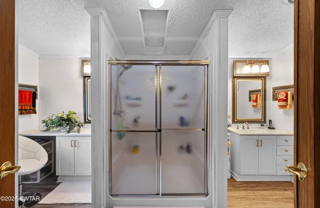 a bathroom with a shower sink and mirror