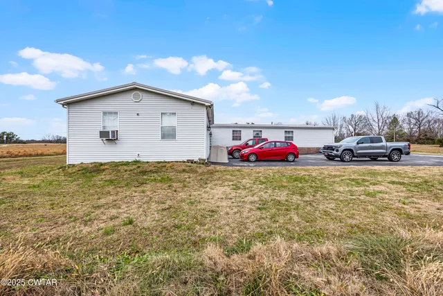 a backyard of a house with table and chairs