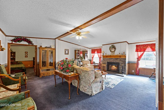 a living room with furniture a fireplace and a flat screen tv