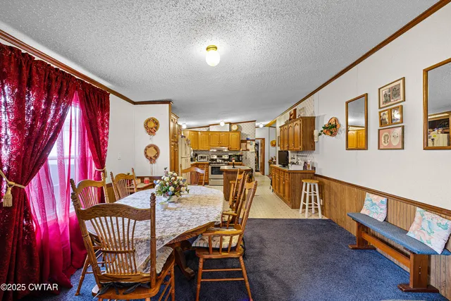 a dining room with furniture a chandelier and wooden floor