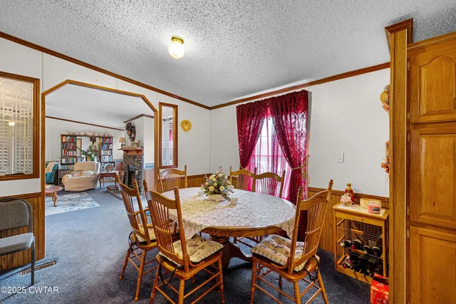 a view of a dining room with furniture and a window