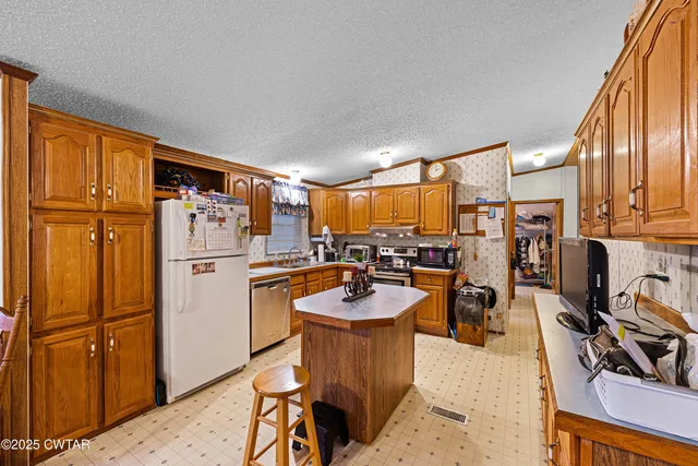 a dining room with furniture a window and kitchen view