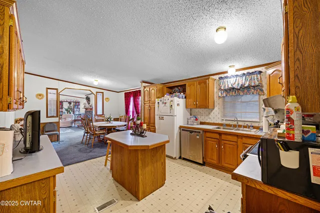 a kitchen with sink stove and chairs