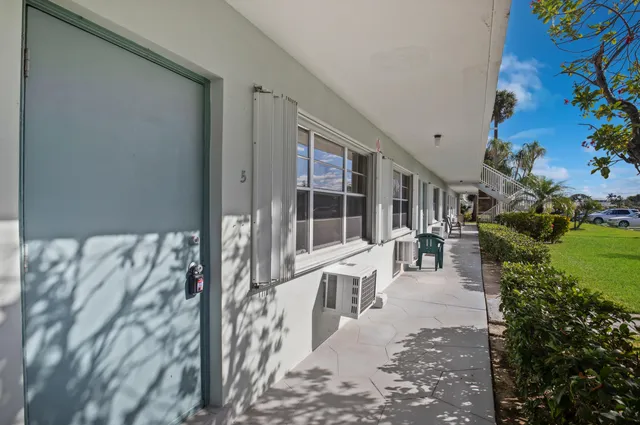 a view of a patio with table and chairs and potted plants